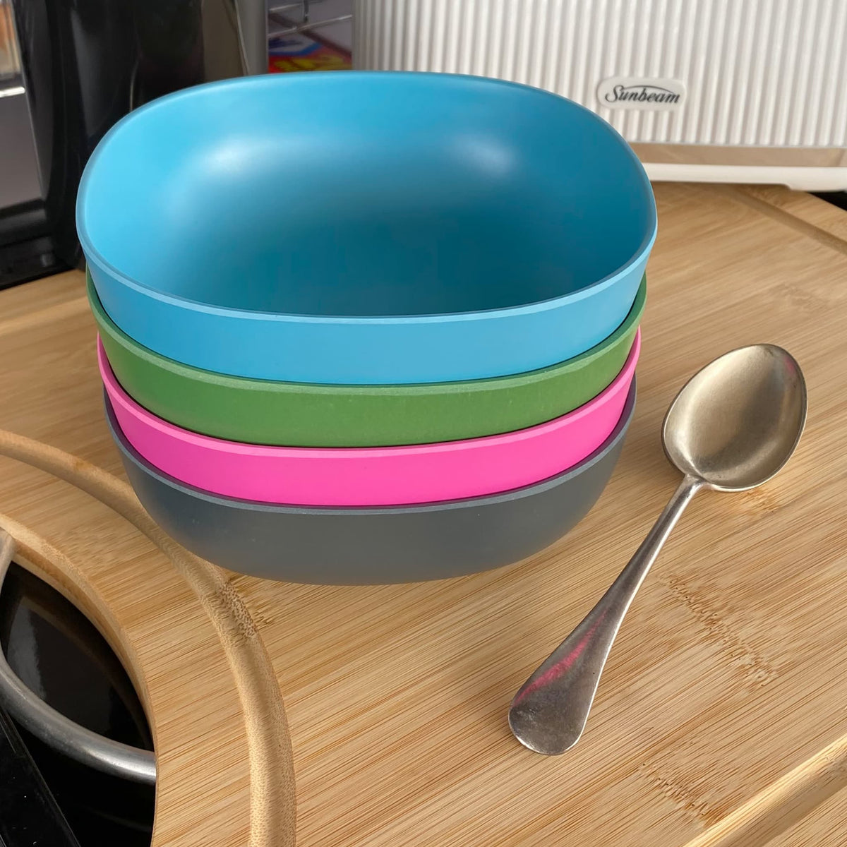 4 piece bamboo cereal bowl set, bush mix in classic green, vintage pink, pale blue and midnight grey, stacked with spoon