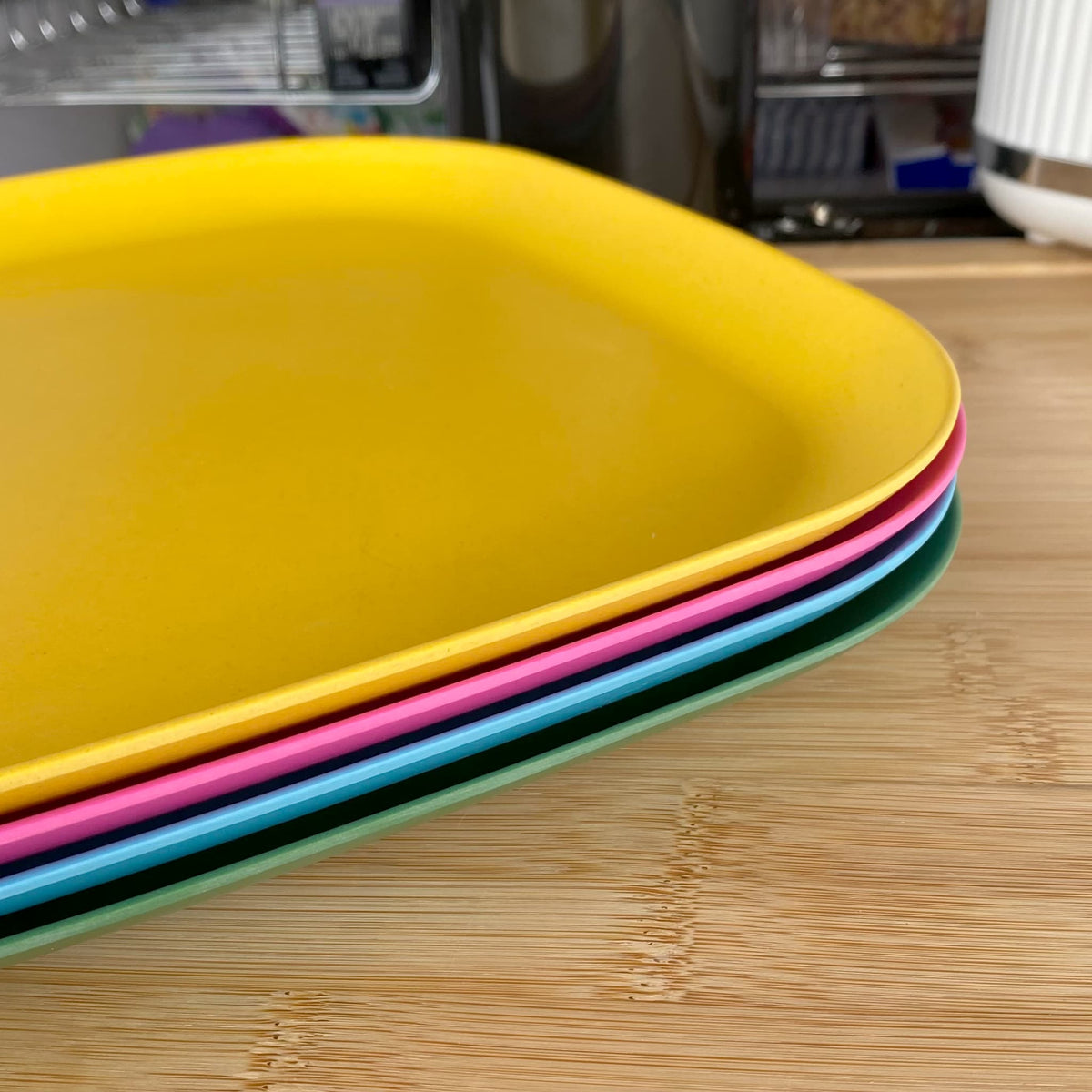 4 piece bamboo plate set, open road mix in classic green, vintage pink, pale blue and sunshine yellow, stacked