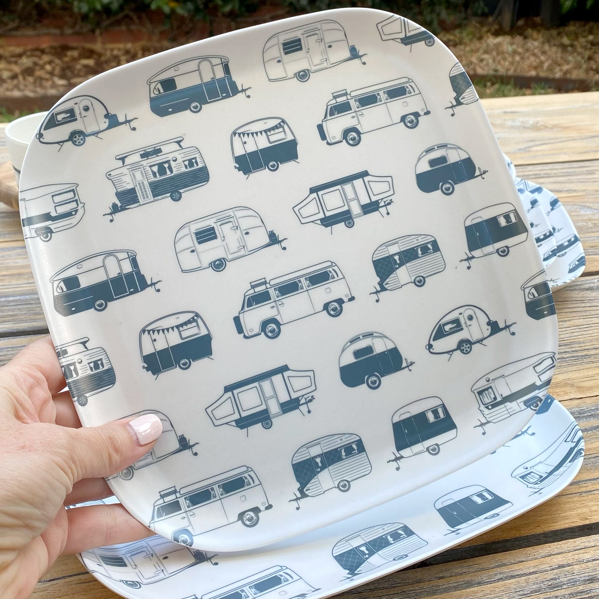 Van Go Caravan and camping 8 piece bamboo dinnerware set in destination collection with midnight grey caravan print including camping plates, bowls and tumblers plus plate closeup on timber table