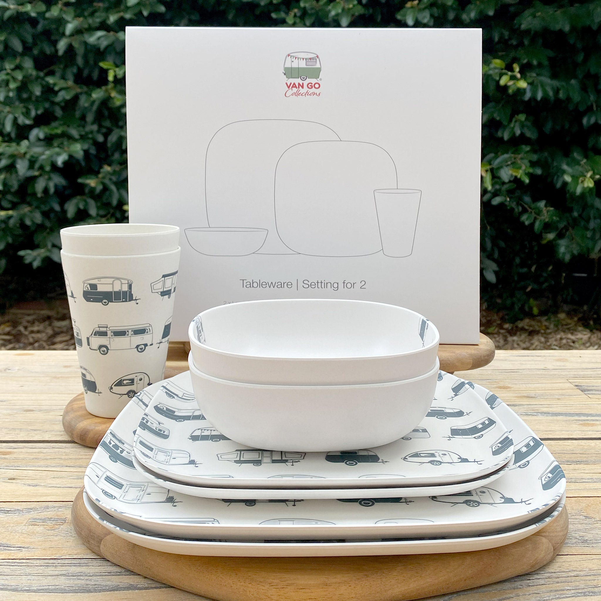 Van Go Caravan and camping 8 piece bamboo dinnerware set in destination collection with midnight grey caravan print including camping plates, bowls and tumblers stacked on timber table with gift box