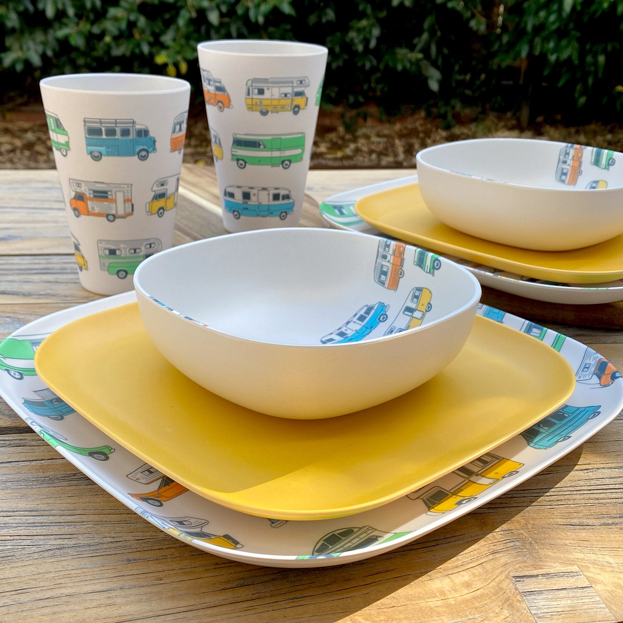 Van Go Camper 8 piece bamboo dinnerware set camping plate, bowl and tumblers plus sunshine yellow plate on timber table