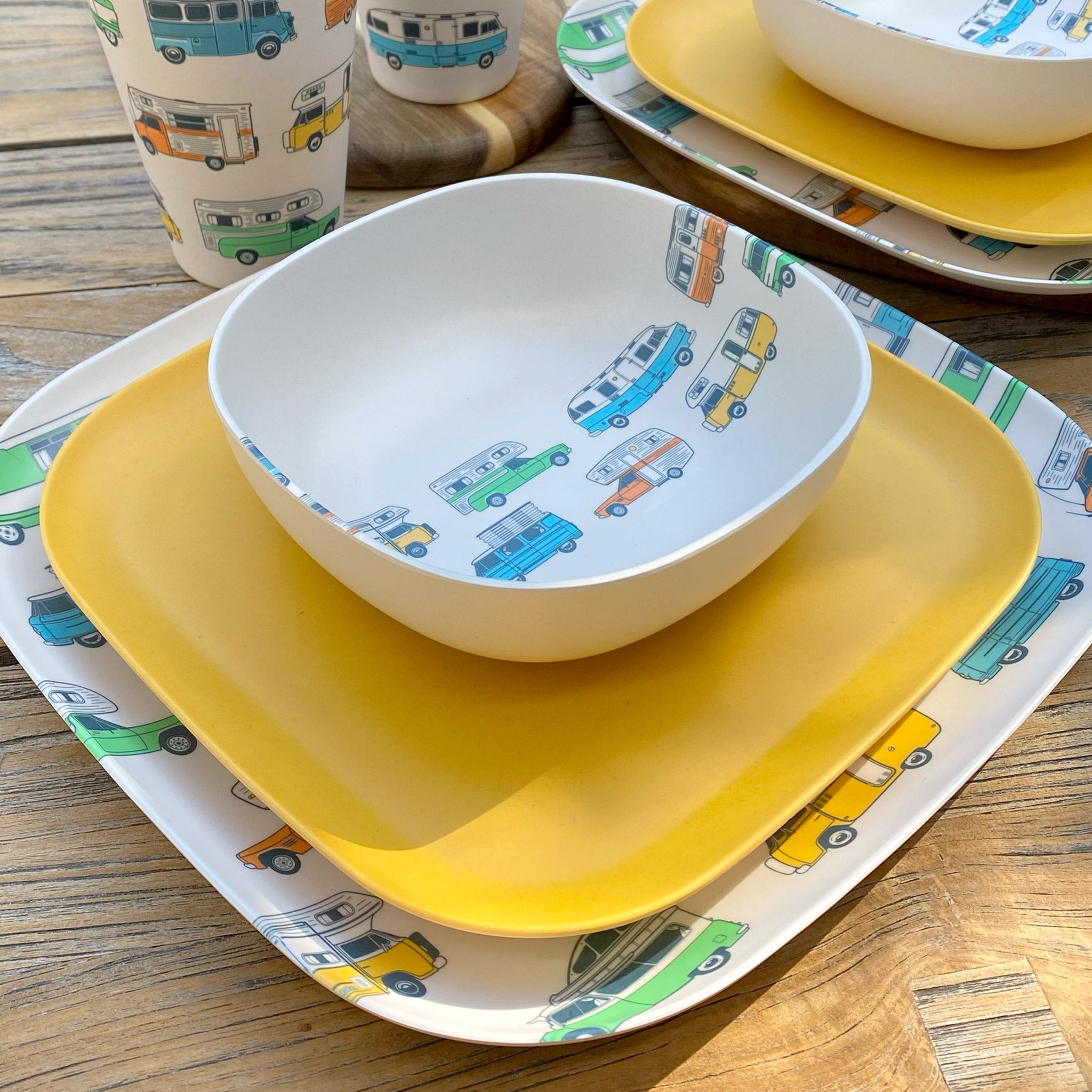 Van Go Camper 8 piece bamboo dinnerware set camping plate, bowl and tumblers plus sunshine yellow plate closeup on table