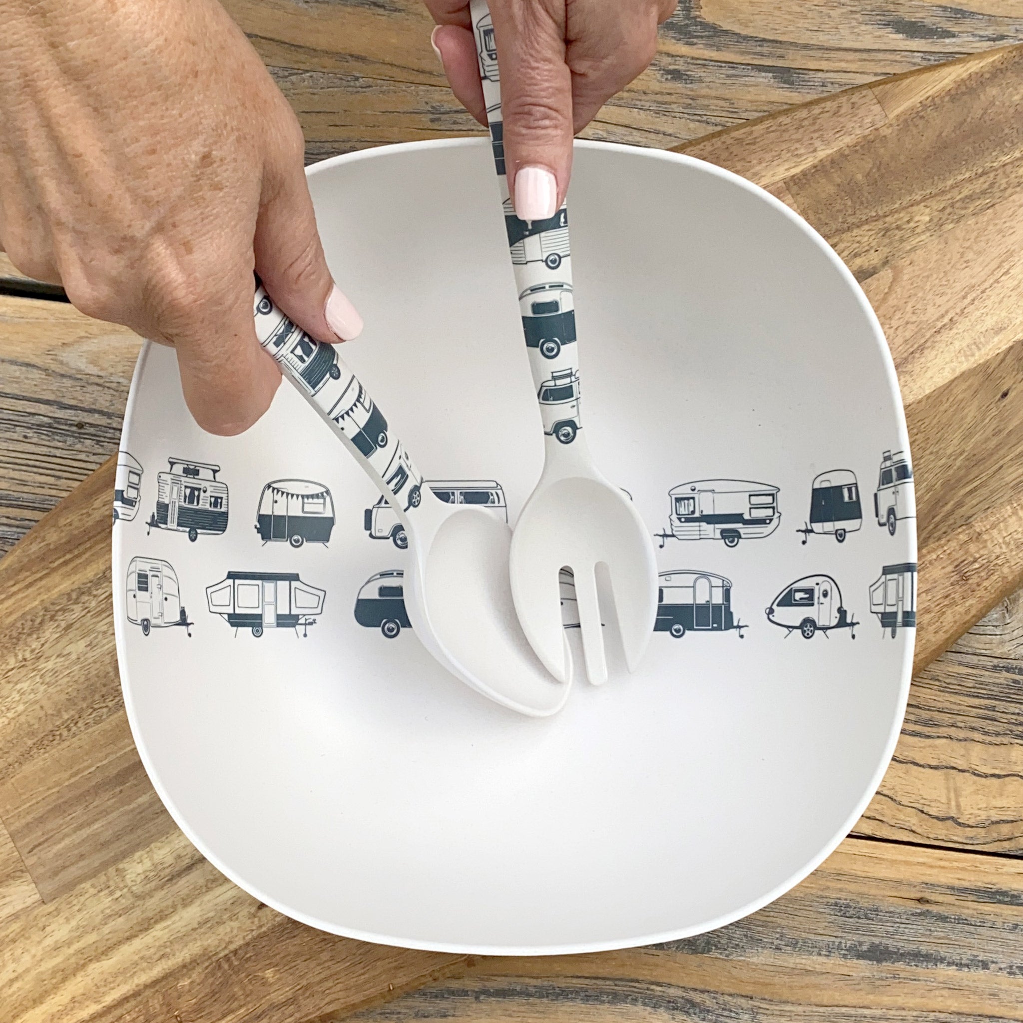 Van Go Bamboo Salad Bowl and Servers Set grey caravan destinations collection salad bowl with matching salad servers in hands displayed on timber board and table, birds eye view.