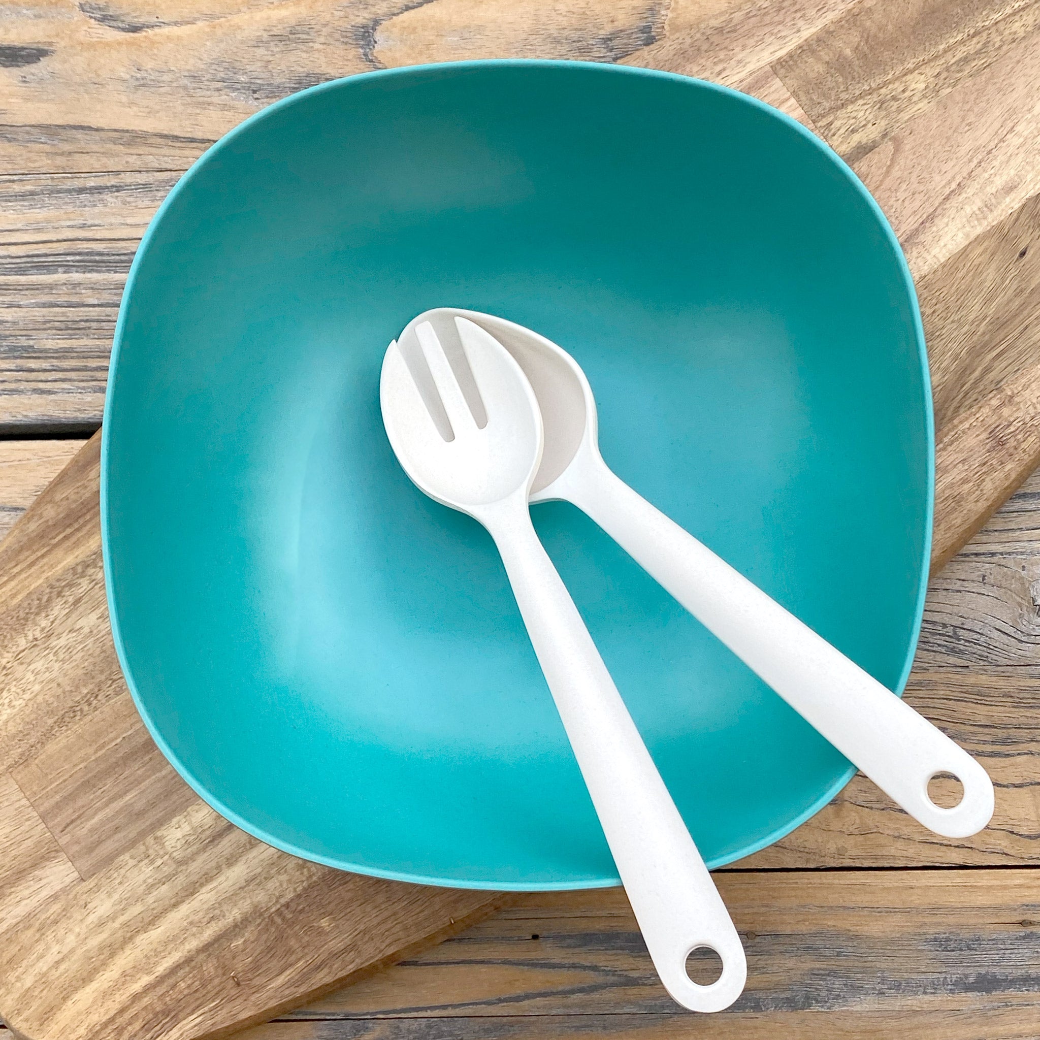 Van Go Bamboo Salad Bowl and Servers Set teal green salad bowl with natural salad servers displayed on timber board and table