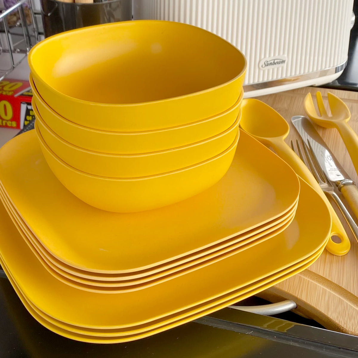 4 piece bamboo cereal bowl set, 4 piece bamboo 22cm plate set and 4 piece bamboo 26cm plate set in sunshine yellow, stacked
