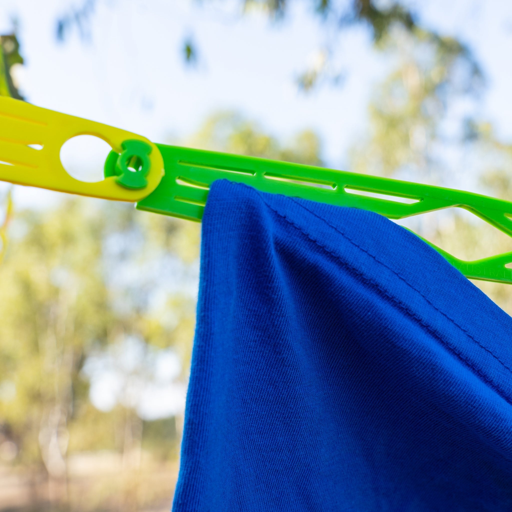Close-up of Slide n' Dry rainbow pegless clothesline slides clicked together showing gripping slots