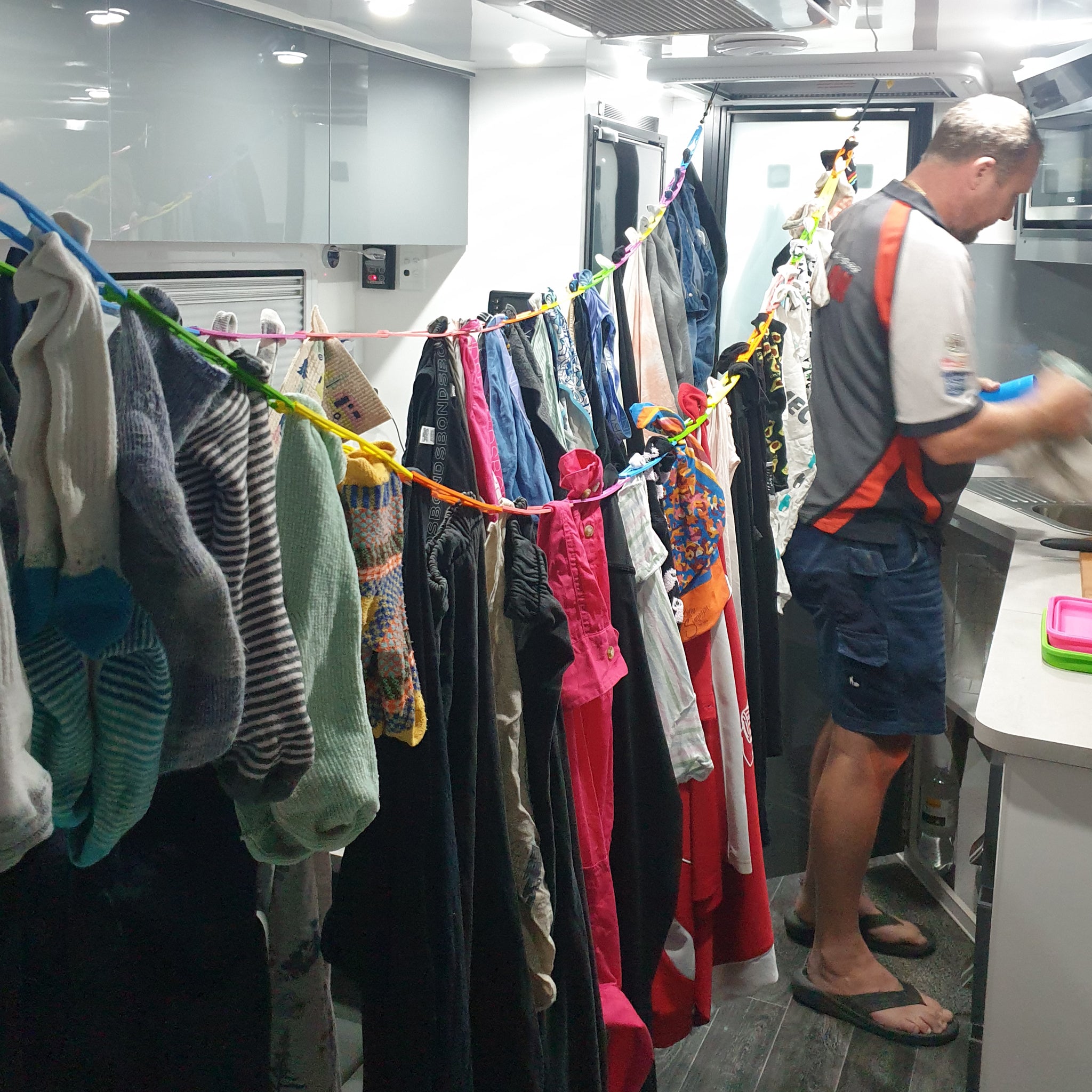 Full load of washing including towels jeans and bathers hanging on Slide n' Dry rainbow pegless caravan clothes line