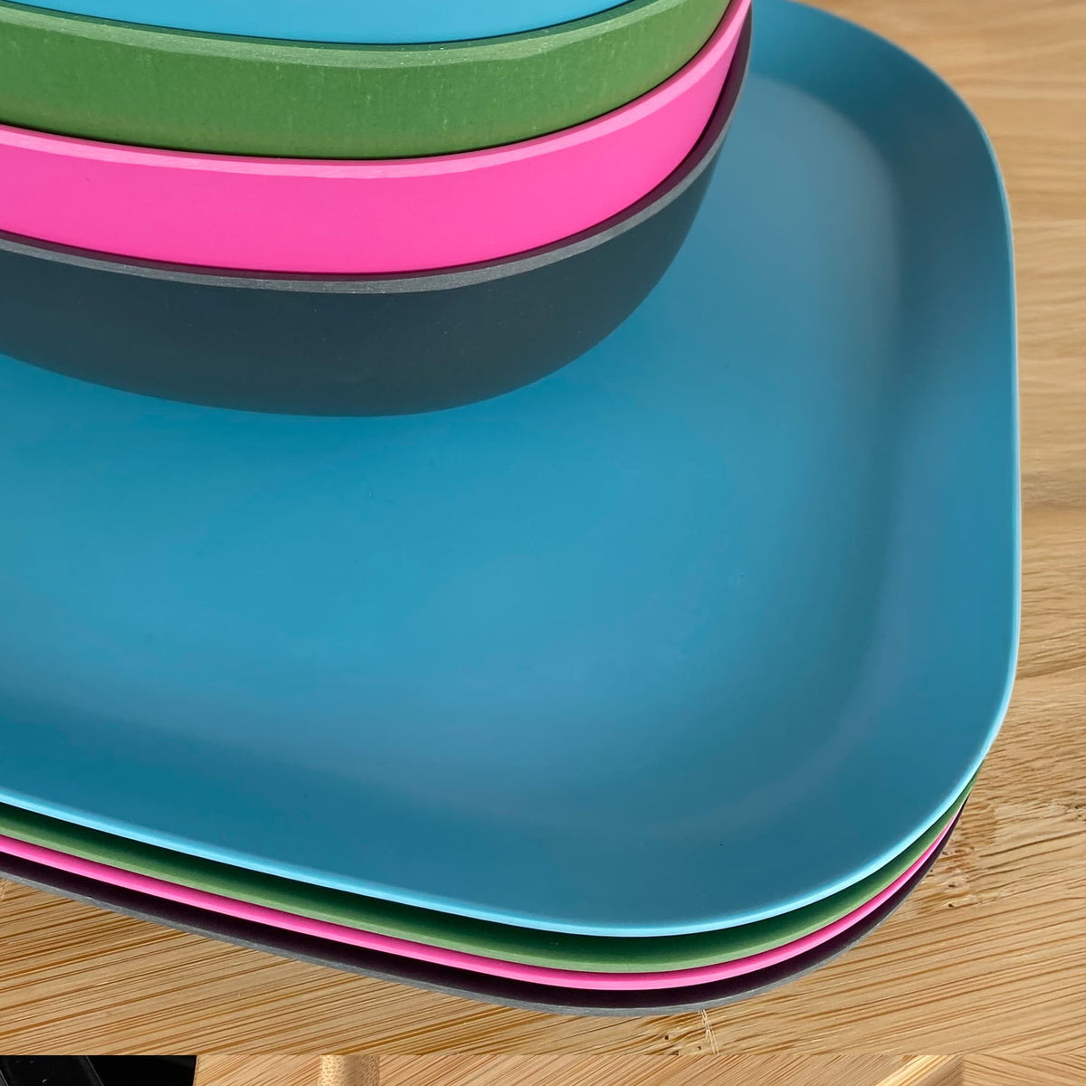 4 piece bamboo plate set 22cm, bush mix in classic green, vintage pink, pale blue and midnight grey, showing curved edge