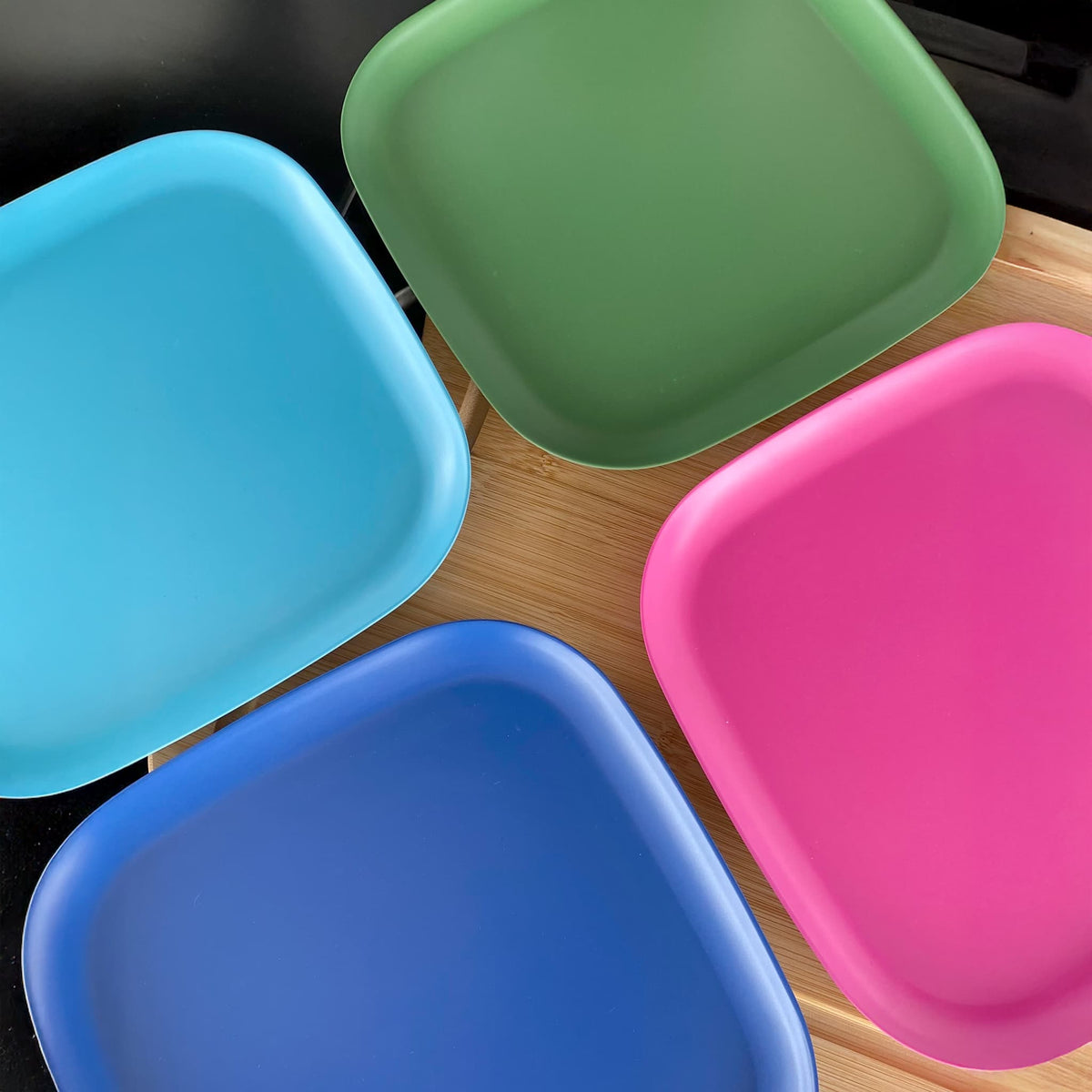 4 piece bamboo plate set 22cm, coastal mix in classic green, vintage pink, pale blue and sea blue, on timber board