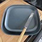 bamboo plates 22cm and 26cm with knife, midnight grey, on caravan table
