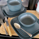 4 piece bamboo cereal bowl set, 22cm plate set and 26cm plate set in midnight grey, stacked and flat with cutlery