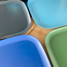 4 piece bamboo plate set, high country mix in classic green, midnight grey, pale blue and sea blue, on timber board