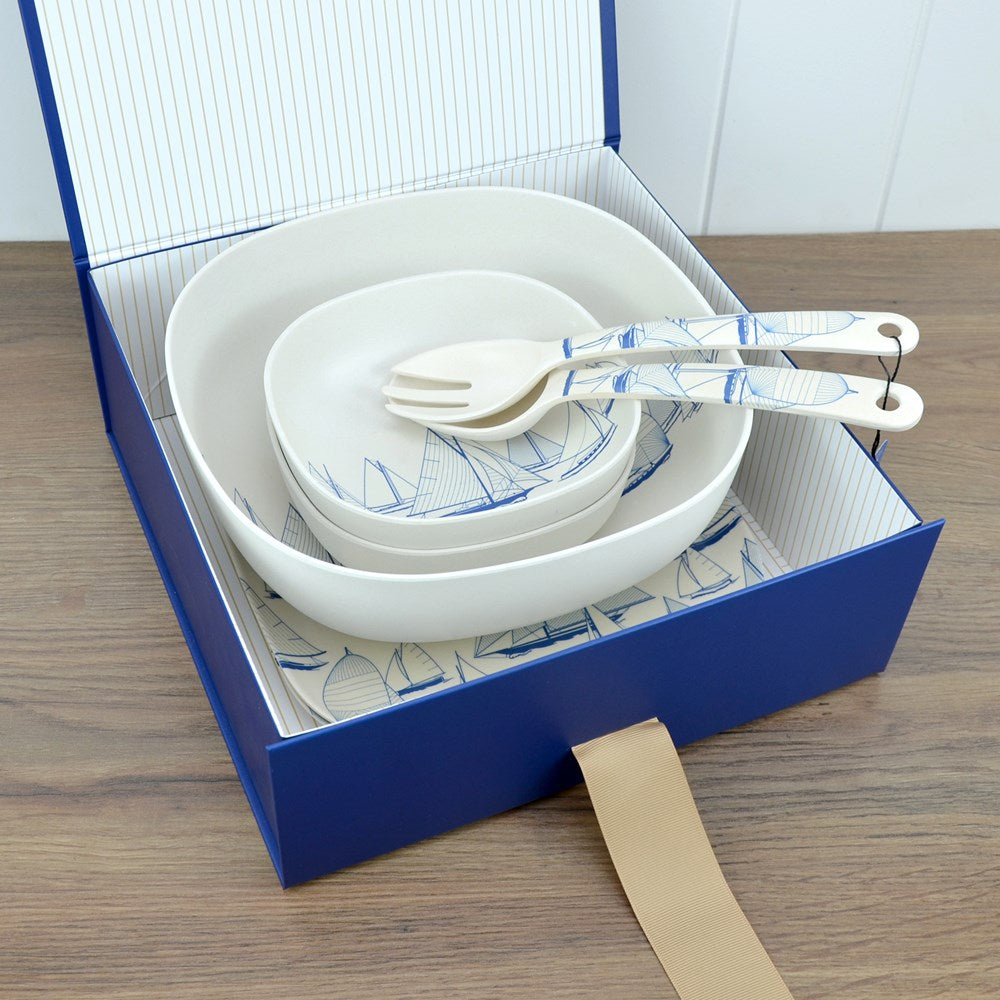 Van Go Collections NautiGo Bamboo Tableware Set includes 2 x 22cm Plates, 2 Cereal Bowls, a Salad Bowl, and Salad Servers in a blue gift box with striped lining and grosgrain ribbon.