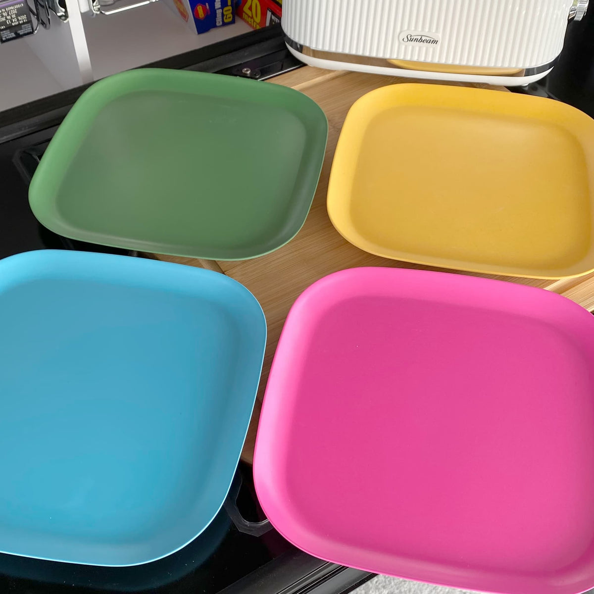 4 piece bamboo plate set 22cm, open road mix in classic green, vintage pink, pale blue and sunshine yellow, on timber board