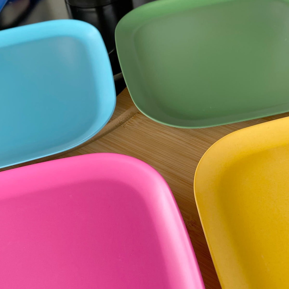 4 piece bamboo plate set 26cm, open road mix in classic green, vintage pink, pale blue and sunshine yellow, on timber board