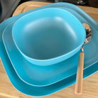 bamboo bowl, plate 22cm and 26cm in pale blue, on table with spoon