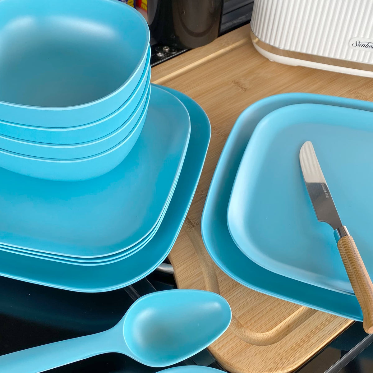 4 piece bamboo cereal bowl set, 22cm plate set and 26cm plate set in pale blue, stacked and flat