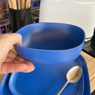 bamboo cereal bowl 15cm in sea blue, held in hand