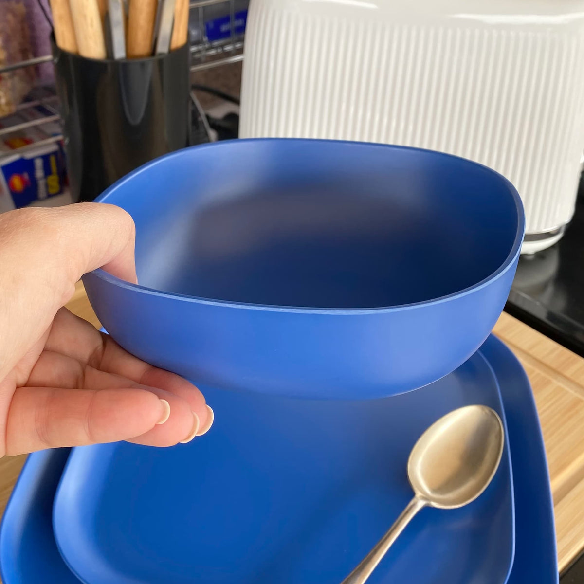 bamboo cereal bowl 15cm in sea blue, held in hand
