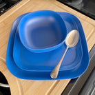bamboo bowl, plate 22cm and 26cm in sea blue, on table with spoon