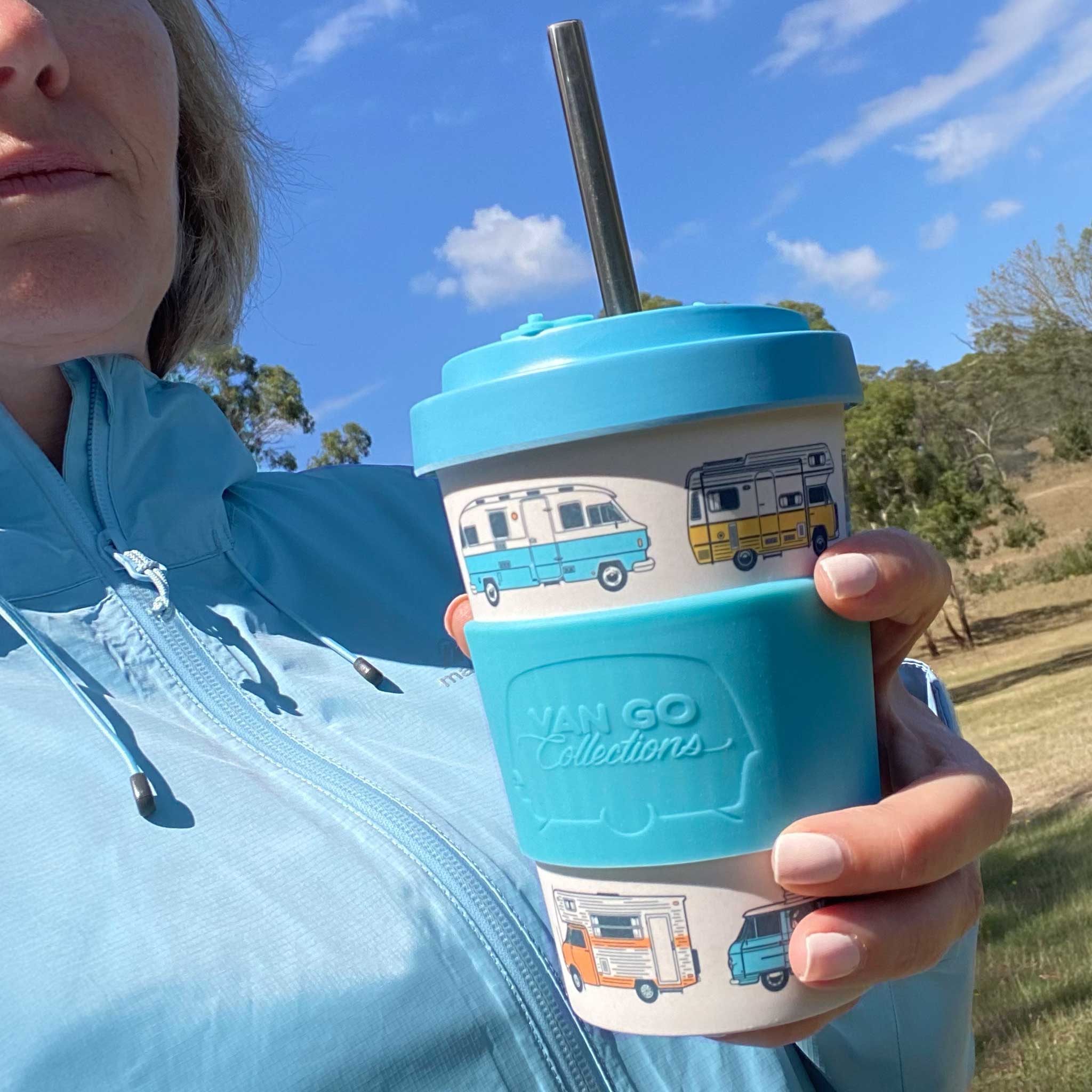 Van Go Bamboo Travel Mug 400ml, BPA free pale blue camper reusable keep cup with spill proof lid in hand while person walking