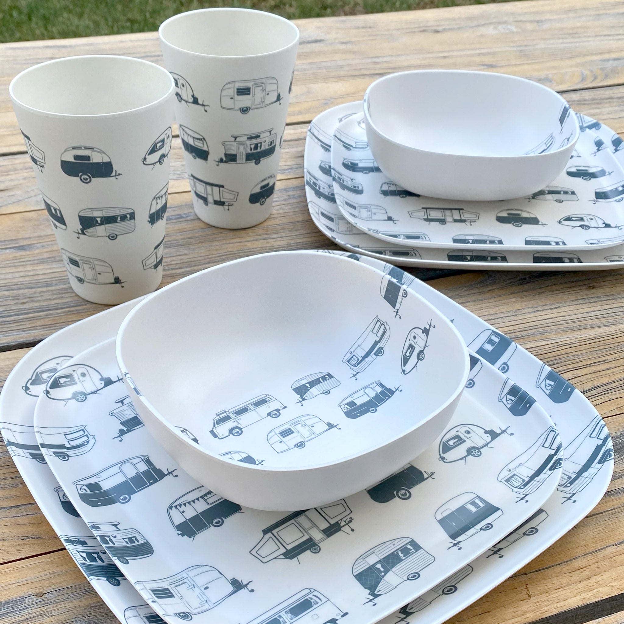 Van Go Caravan and camping 8 piece bamboo dinnerware set in destination collection with midnight grey caravan print including camping plates, bowls and tumblers on timber table