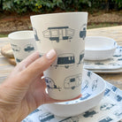 Van Go Caravan and camping 8 piece bamboo dinnerware set in destination collection with midnight grey caravan print including camping plates, bowls and tumblers plus tumbler closeup on timber table
