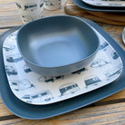 Van Go Caravan and camping 8 piece bamboo dinnerware set destinations collection van living plate and caravan tumbler plus midnight grey camping bowl and large plate on timber table with spoons semi-closeup