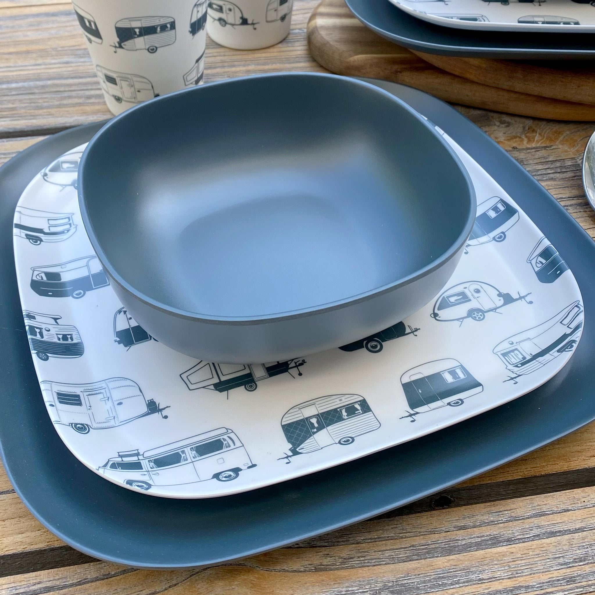 Van Go Caravan and camping 8 piece bamboo dinnerware set destinations collection van living plate and caravan tumbler plus midnight grey camping bowl and large plate on timber table with spoons semi-closeup