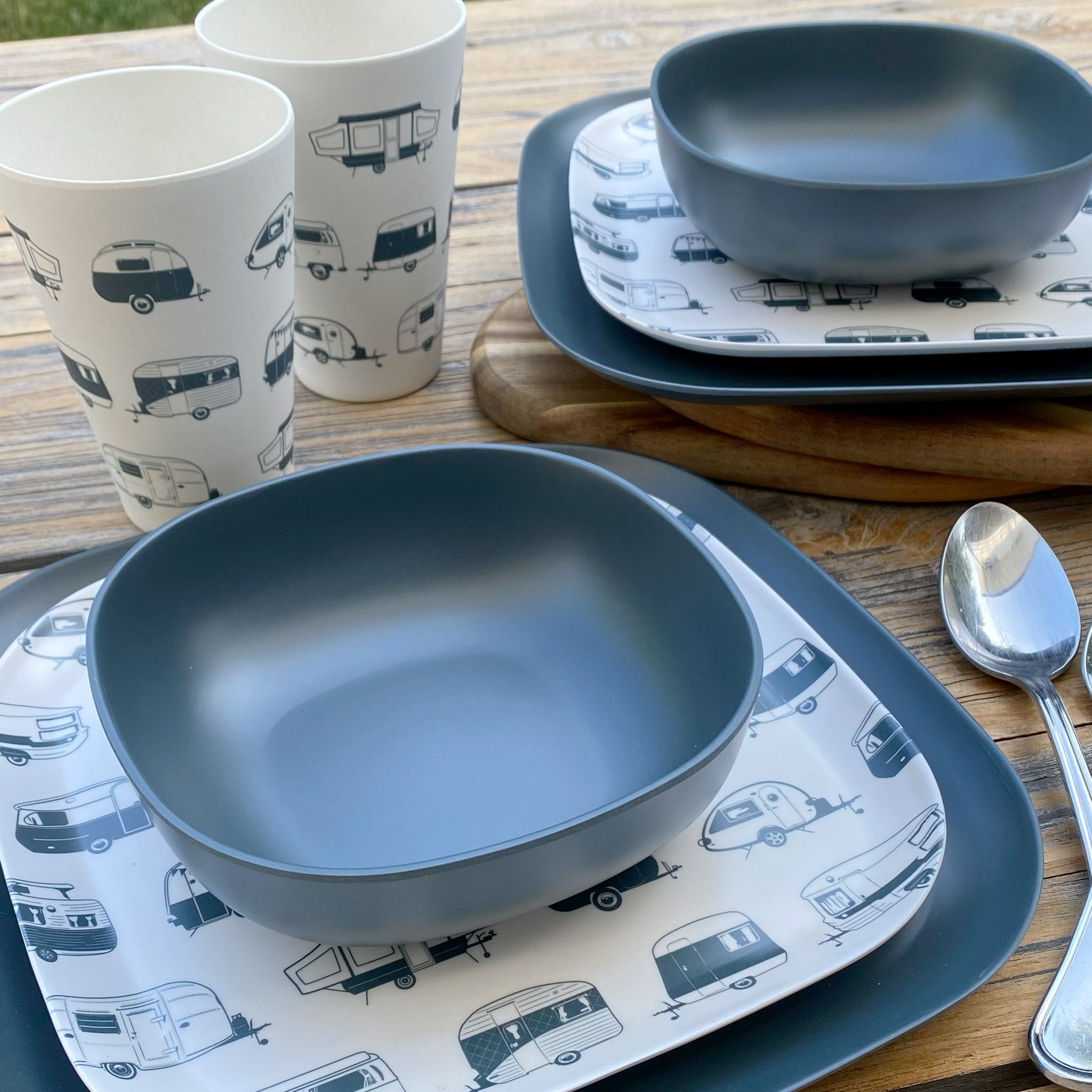 Van Go Caravan and camping 8 piece bamboo dinnerware set destinations collection van living plate and caravan tumbler plus midnight grey camping bowl and large plate on timber table side view with spoons