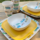 Van Go Caravan and camping 8 piece bamboo dinnerware set Camper plate, bowl and tumblers plus sunshine yellow plate on timber table cropped