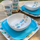 Van Go Caravan and camping 8 piece bamboo dinnerware set for 2 people. Camper plate, bowl and tumblers plus pale sky blue plates on timber table