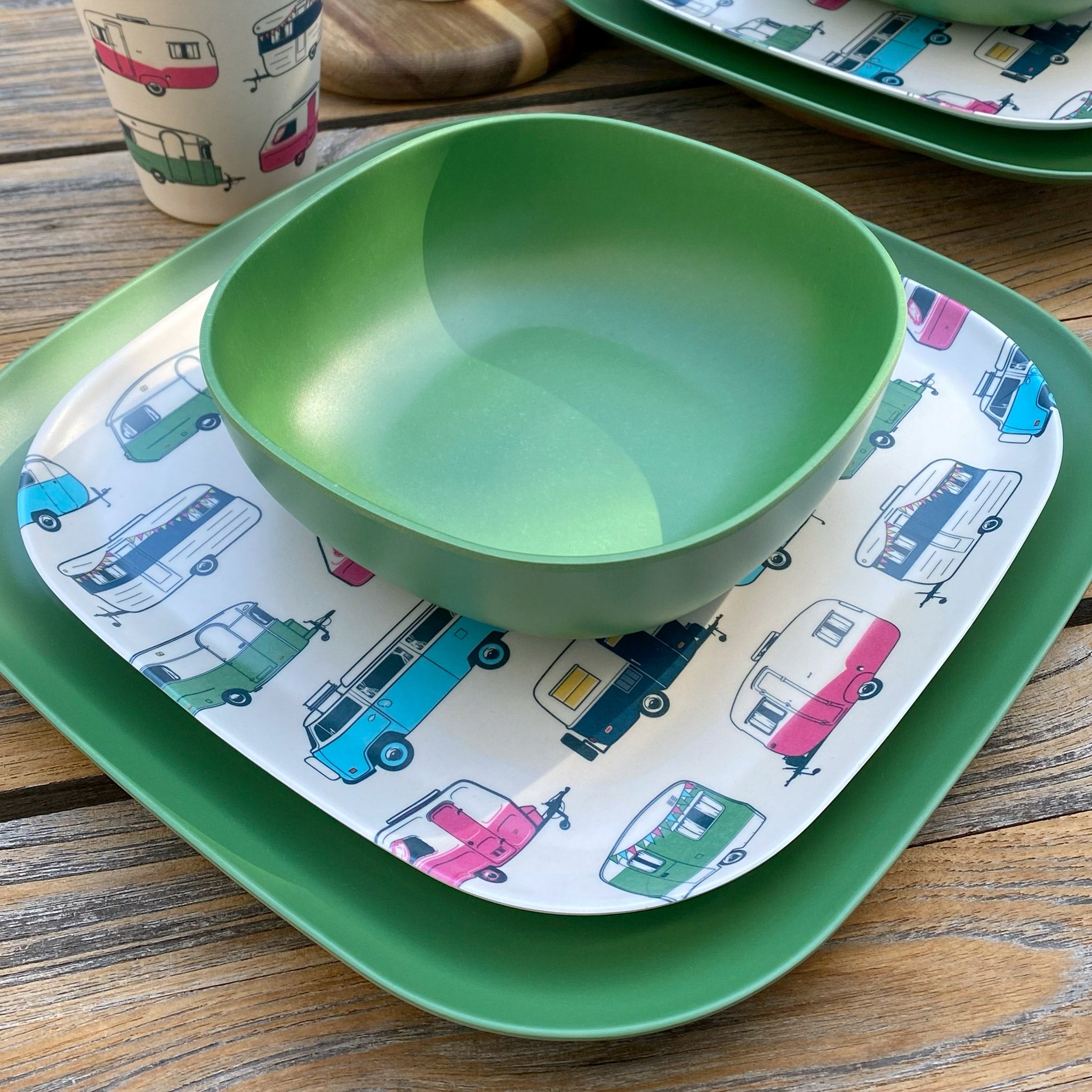 Van Go Caravan and camping 8 piece bamboo dinnerware set Iconic van living plate plus classic green camping bowl and large plate on timber table closeup