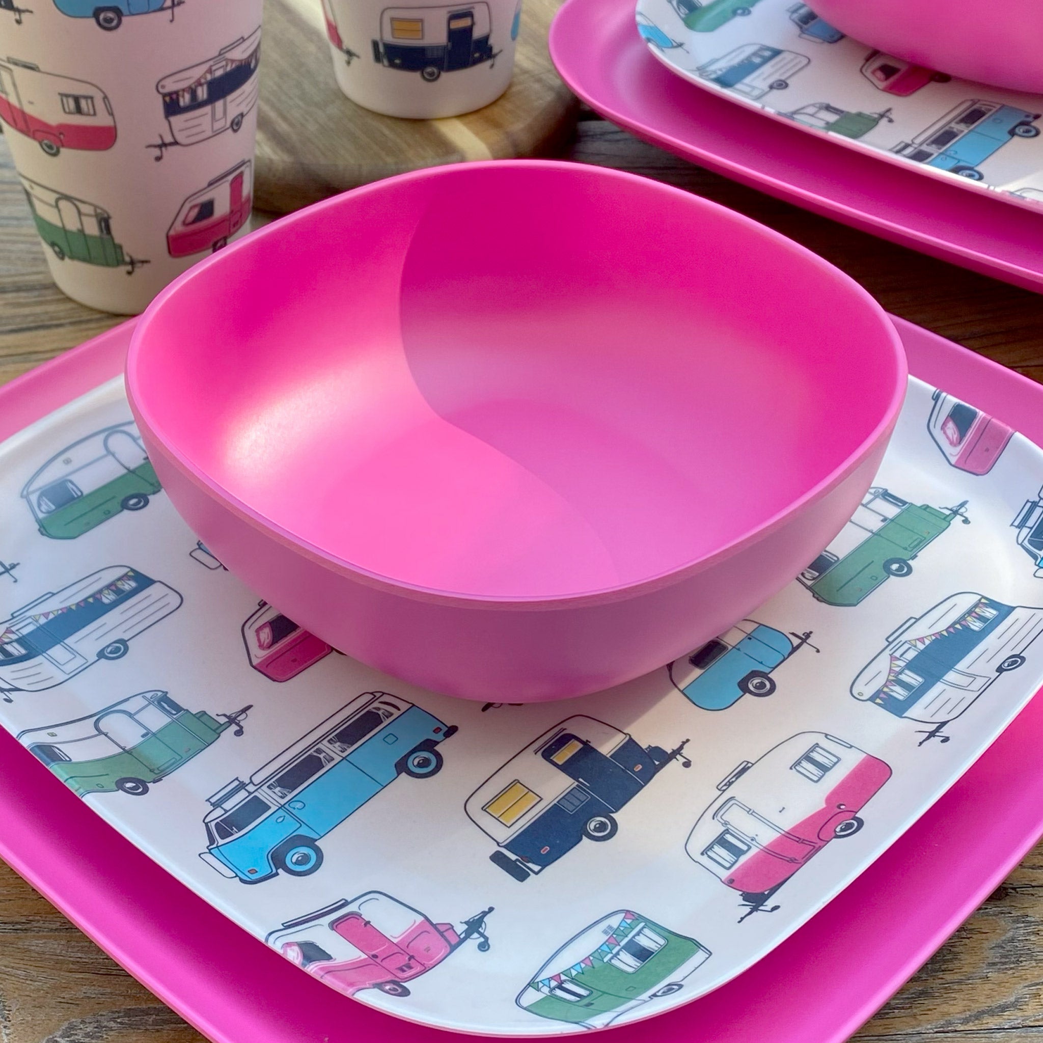 Van Go Caravan and camping 8 piece bamboo dinnerware set Iconic van living plate and caravan tumbler plus vintage pink camping bowl and large plate on timber table closeup
