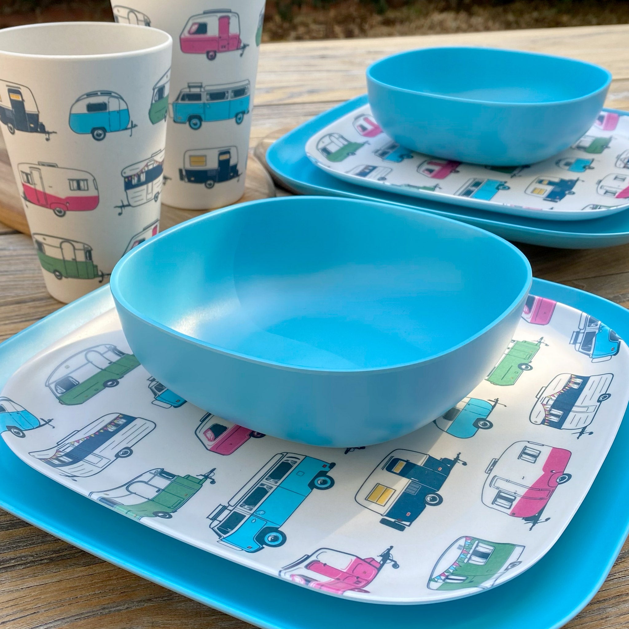 Van Go Caravan and camping 8 piece bamboo dinnerware set Iconic van living plate and caravan tumbler plus pale blue camping bowl on timber table side view