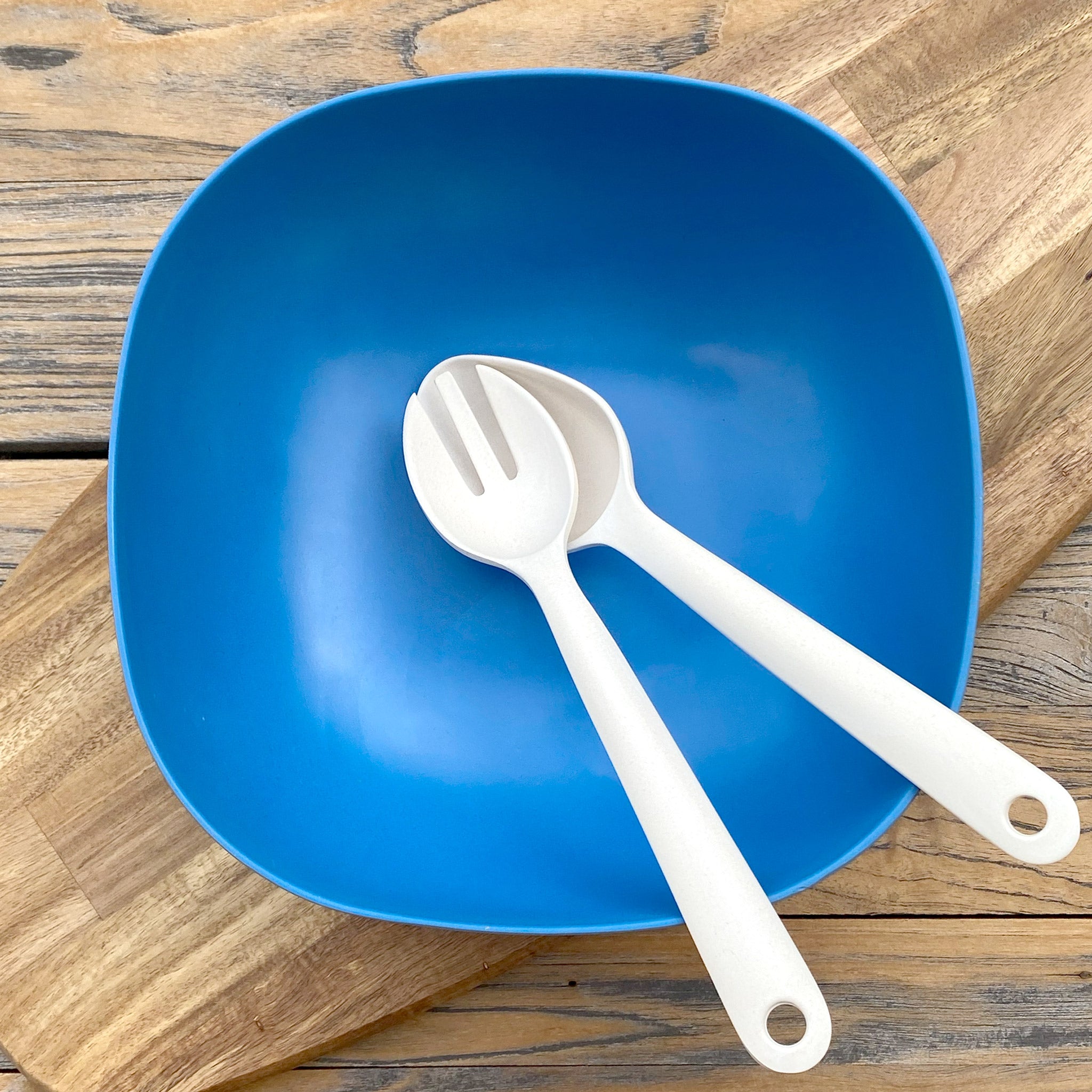Van Go Bamboo Salad Bowl and Servers Set in cobalt blue with natural salad servers displayed on timber board