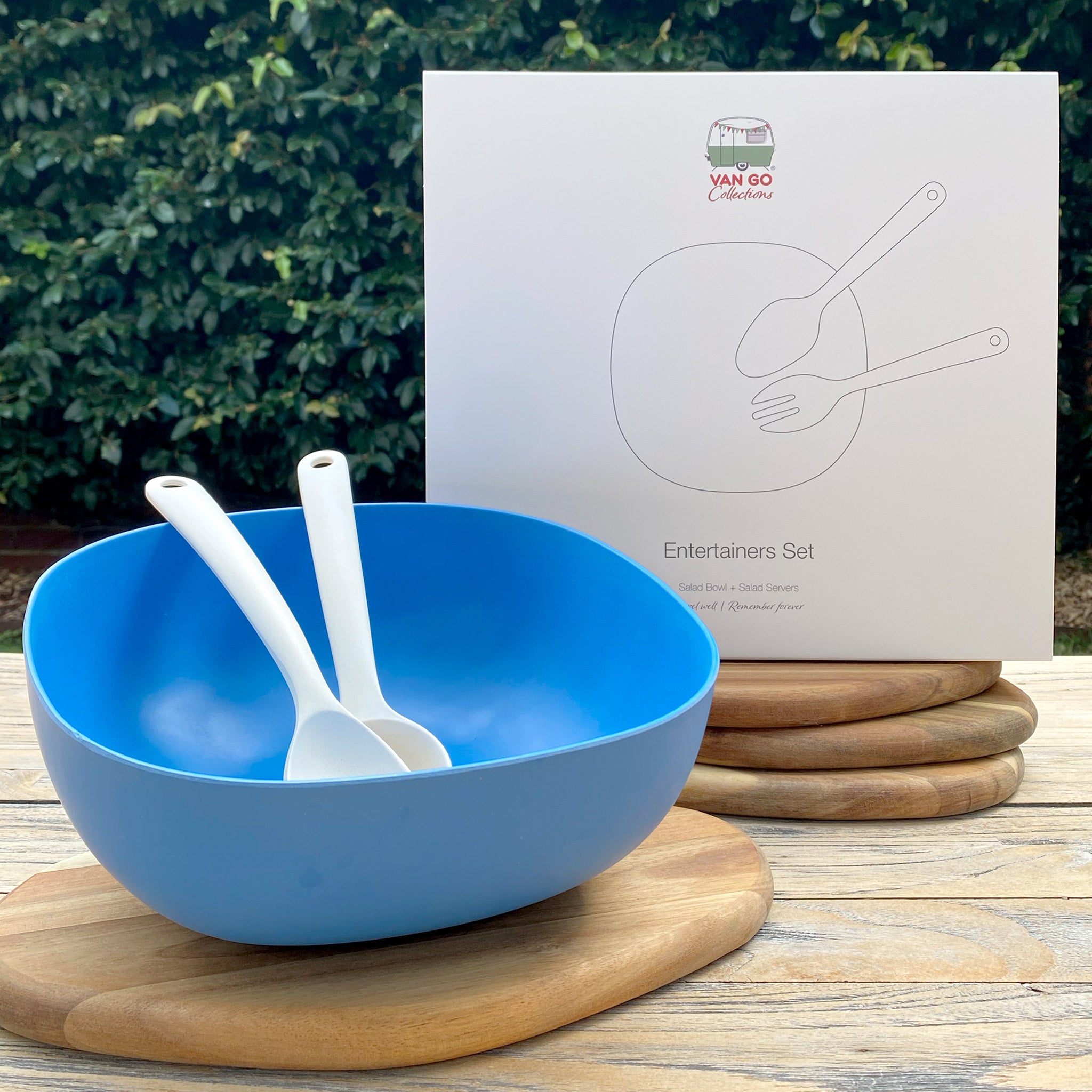 Van Go Bamboo Salad Bowl and Servers Set in cobalt blue with natural salad servers displayed in front of gift box on table