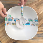 Van Go Bamboo Salad Bowl and Servers Set coloured campervans and motorhomes Camper Collection salad bowl with matching salad servers in hands displayed on timber board and table, birds eye view.