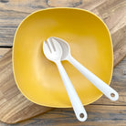 Van Go Bamboo Salad Bowl and Servers Set sunshine yellow salad bowl with natural salad servers displayed on timber board and table birdseye view