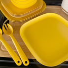 4 piece bamboo cereal bowl set, 22cm plate set and 26cm plate set in sunshine yellow, stacked and flat
