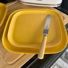 bamboo plate 22cm on 26cm in sunshine yellow, on table with knife