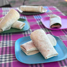 4 piece bamboo plate set 22cm, bush mix in classic green, vintage pink, pale blue and midnight grey, with wraps on camp table